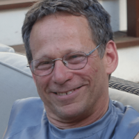 photo of smiling older man with glasses