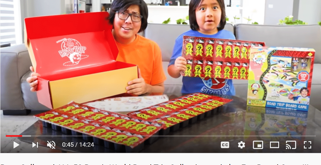 Screenshot of YouTube video with young boy and father facing camera holding toys