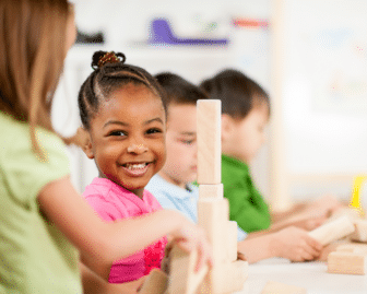 preschooler plays with wooden blocks